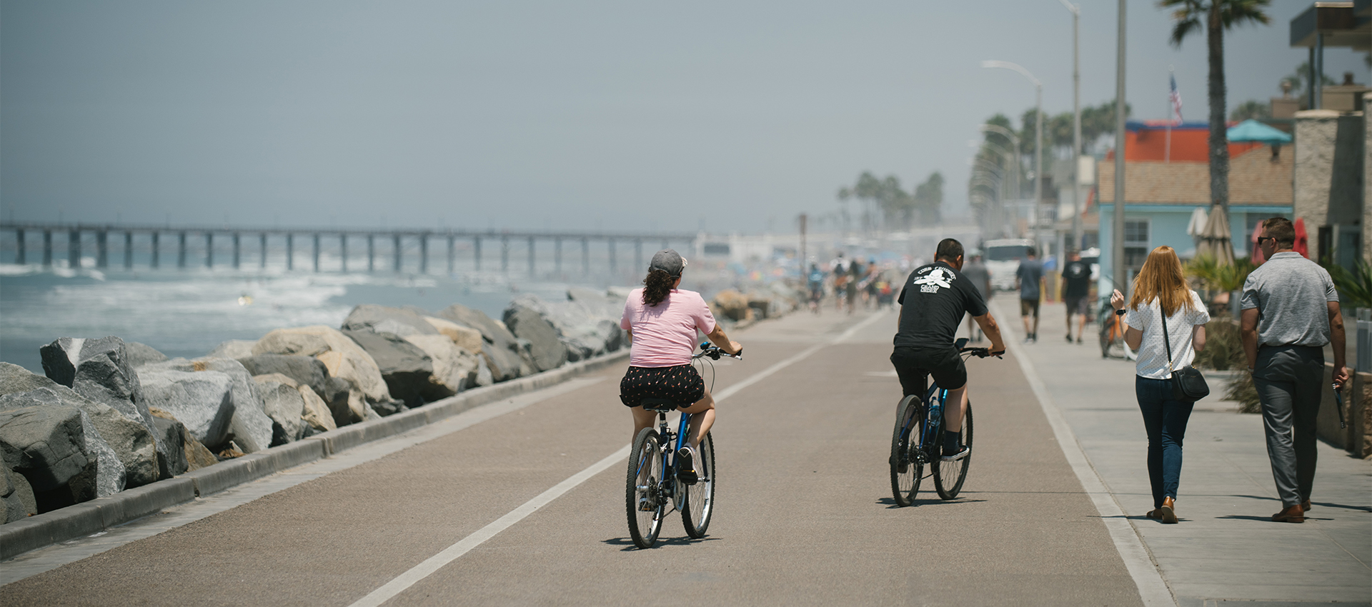 Image of people biking along the bike path near the Oceanside beaches