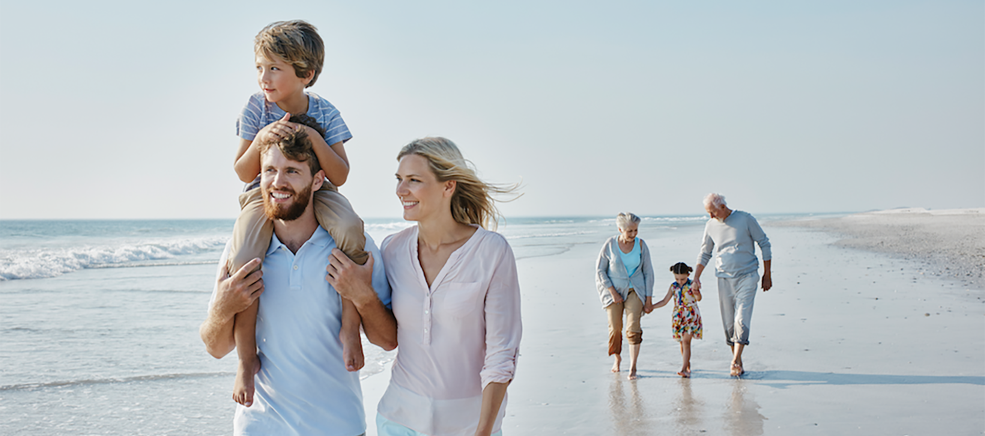 Image of a family walking along the beach