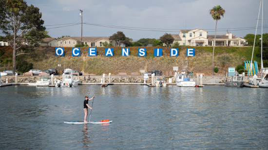 Image of a person paddle boarding in Oceanside CA near 26Tides
